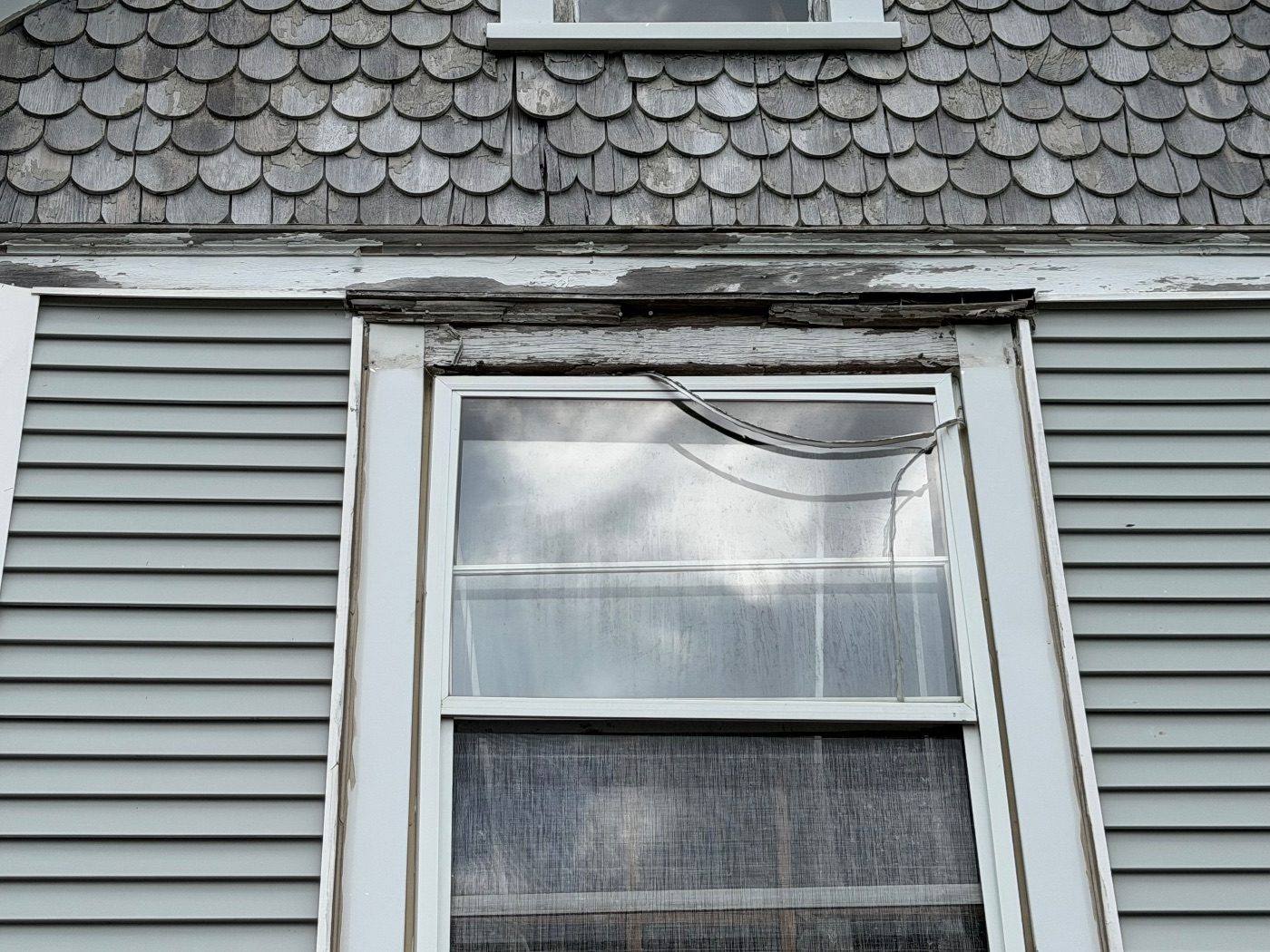 Before: rotted window header — the kind of thing we find and fix