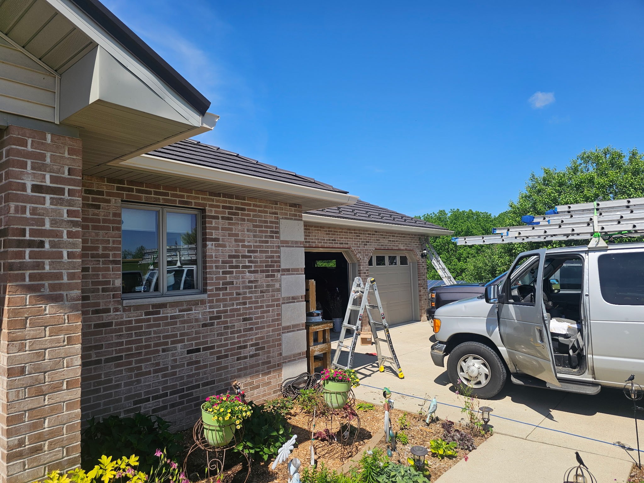 GutterForge crew installing gutter guards on a brick home