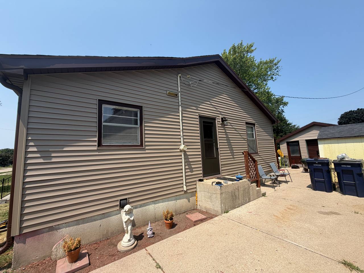 After: same side of the house with fresh new siding and clean roofline